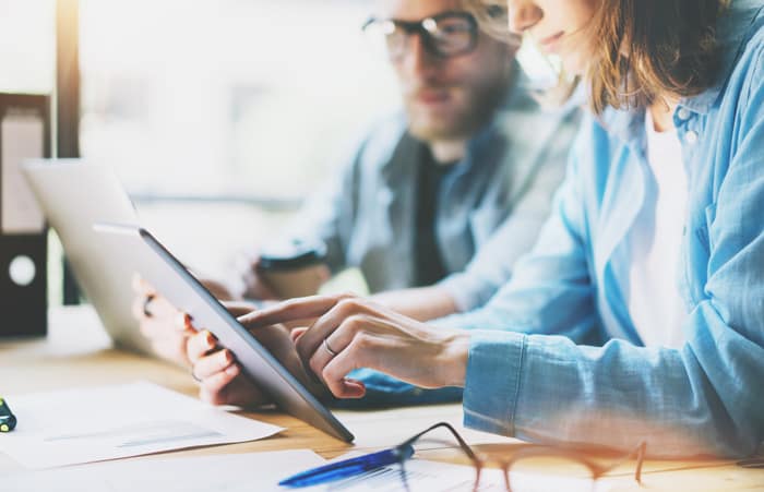 Kuvituskuva, jossa kaksi henkilöä työskentelee projektin parissa toimistolla.